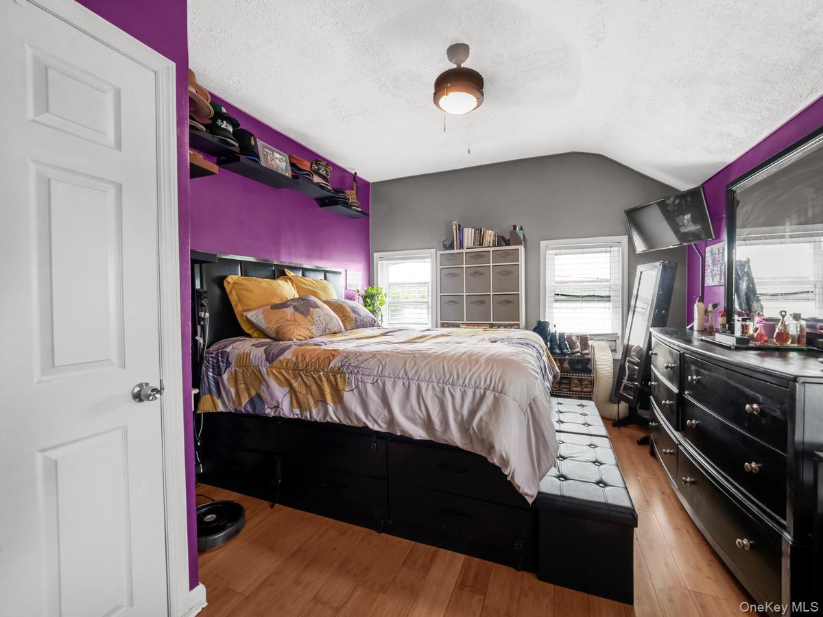 218-12 141st Road Queens, NY 11413 - Photo 11 of 14 a bedroom with a bed and a large window with balcony view