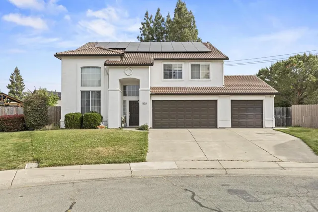 a front view of a house with a garden