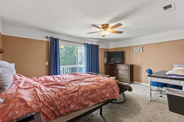 a bed sitting in a bedroom next to a window