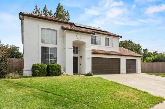 a front view of a house with a garden