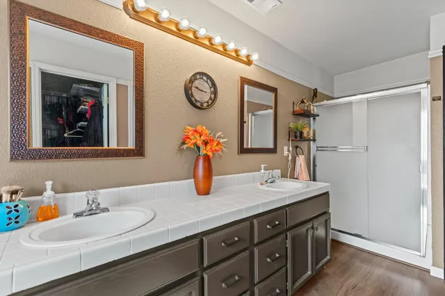 a bathroom with a tub sink and mirror