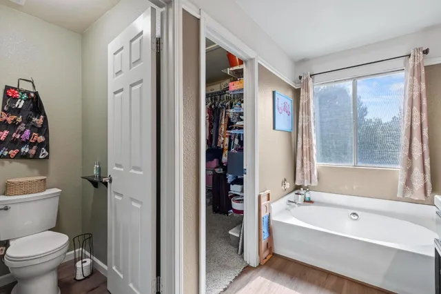 a bathroom with a double vanity sink mirror and toilet