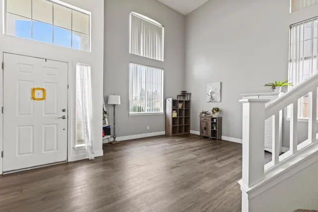 a view of staircase with lots of frames on wall and a window