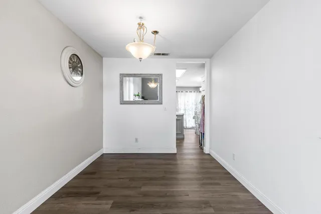 a kitchen with stainless steel appliances white cabinets and white appliances