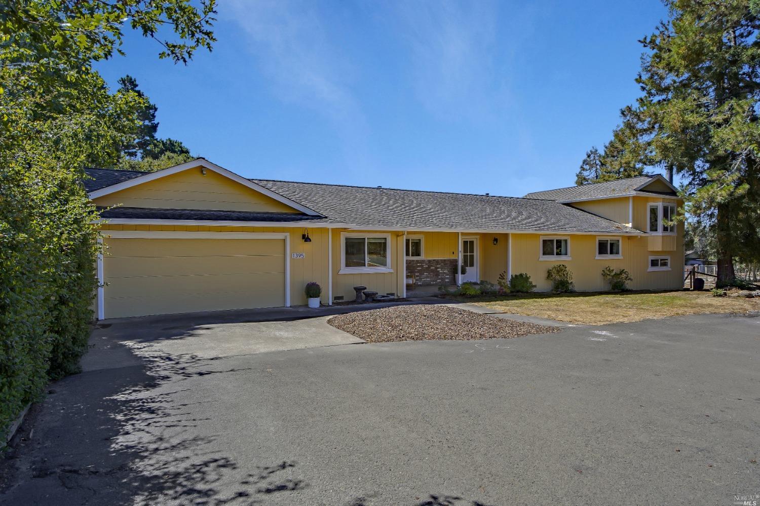 1395 Schaeffer Road Sebastopol, CA 95472 - Photo 1 of 1 a front view of a house with a yard and garage