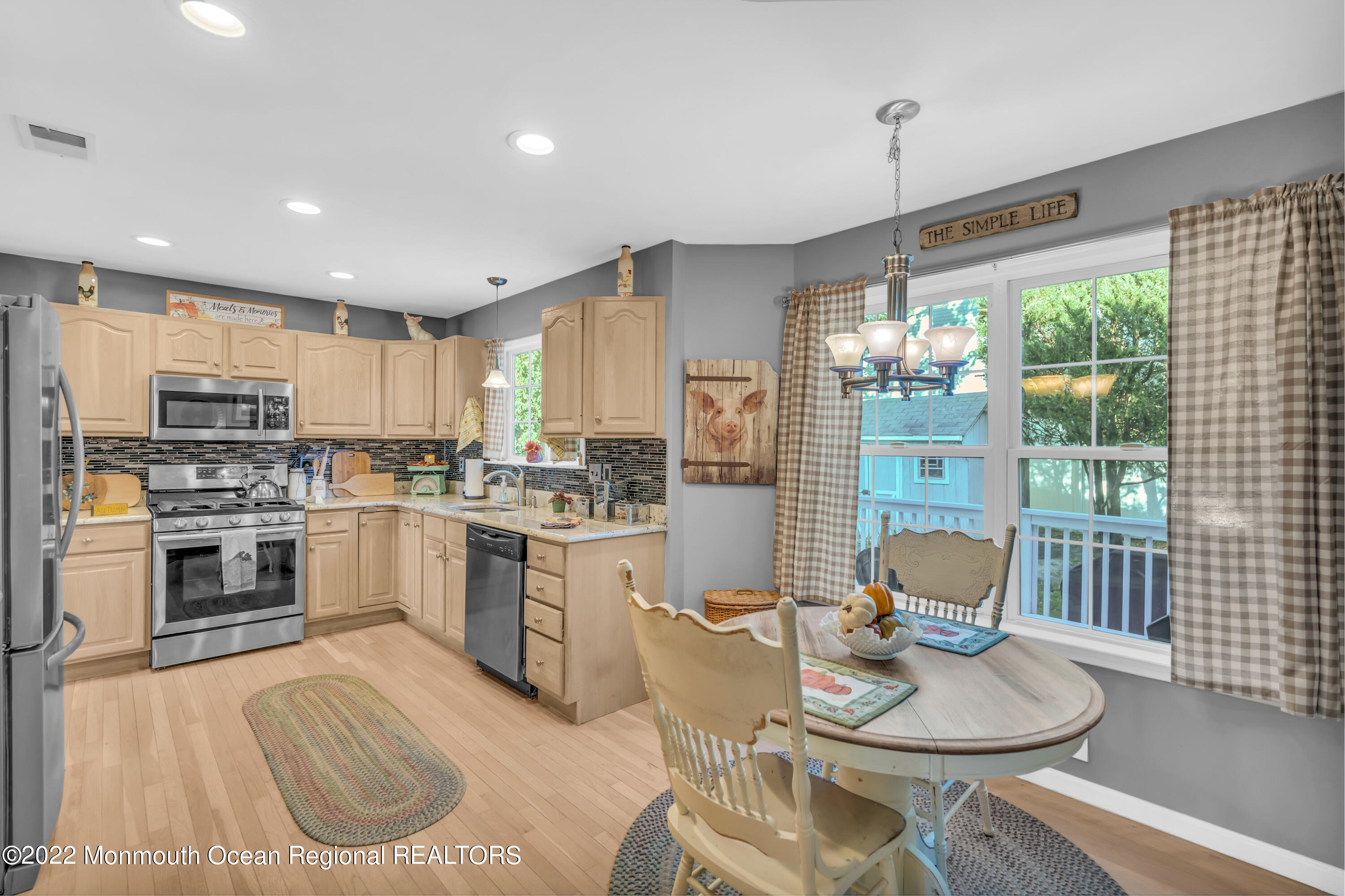 124 Compass Road Manahawkin, NJ 08050 - Photo 13 of 36 a kitchen with sink a stove and chairs