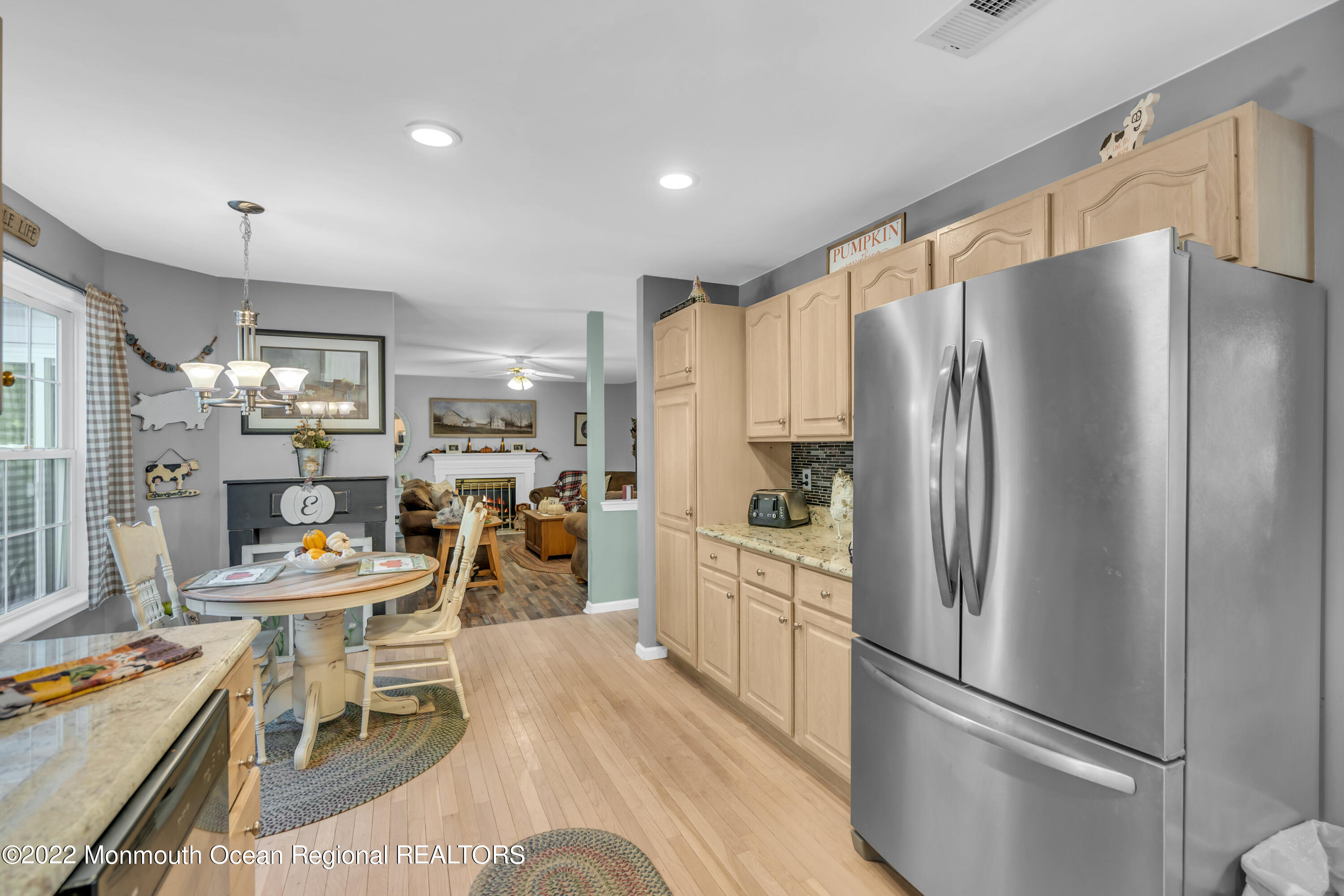 124 Compass Road Manahawkin, NJ 08050 - Photo 14 of 36 a kitchen with stainless steel appliances a refrigerator a stove a dining table and chairs