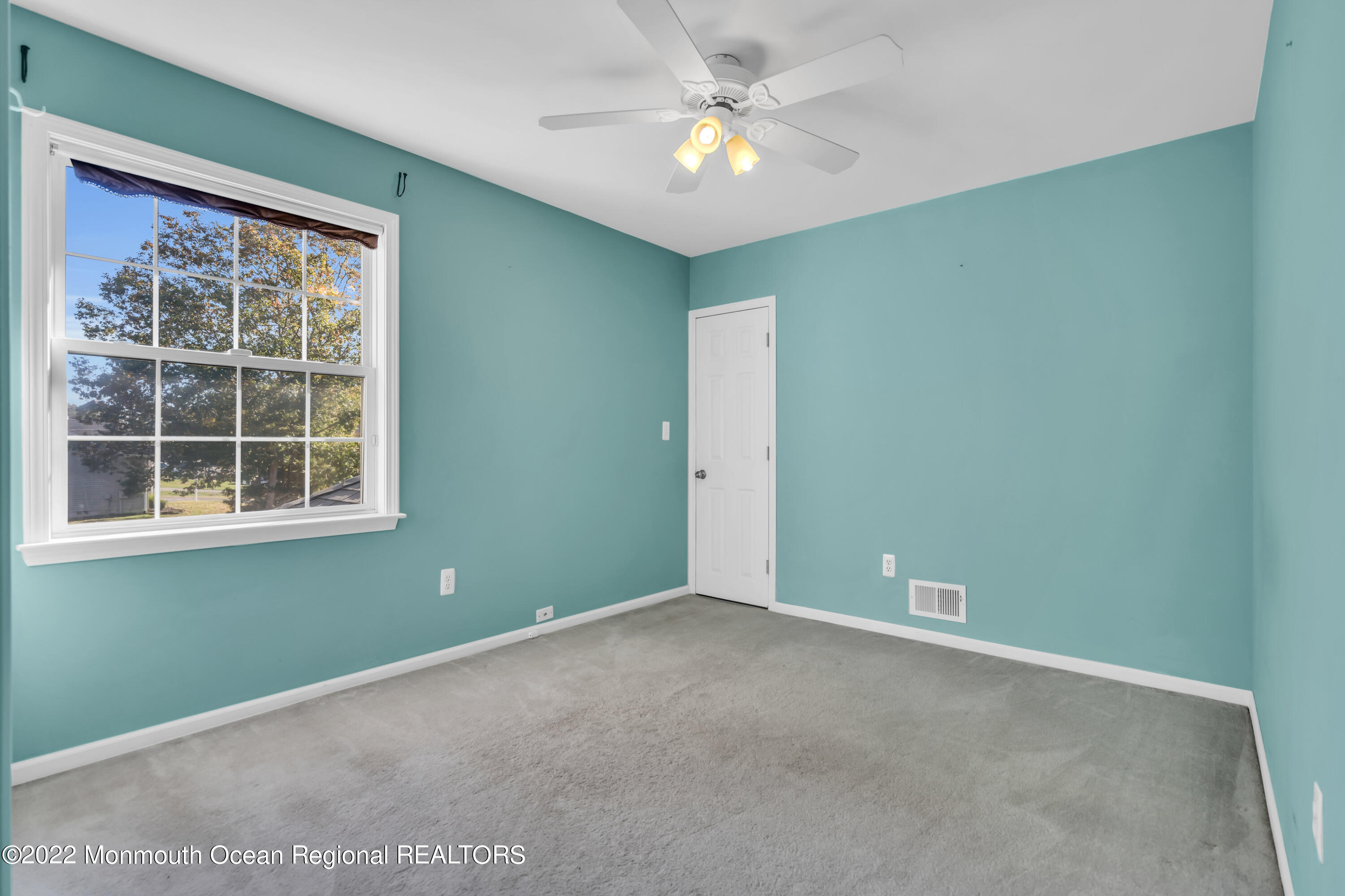 124 Compass Road Manahawkin, NJ 08050 - Photo 27 of 36 an empty room with a window and a fan