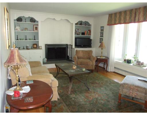 22 Reservoir Avenue Warren, RI 02885 - Photo 3 of 8 Living Room. The living room has a beautiful bow window and cozy wood burning fireplace.
