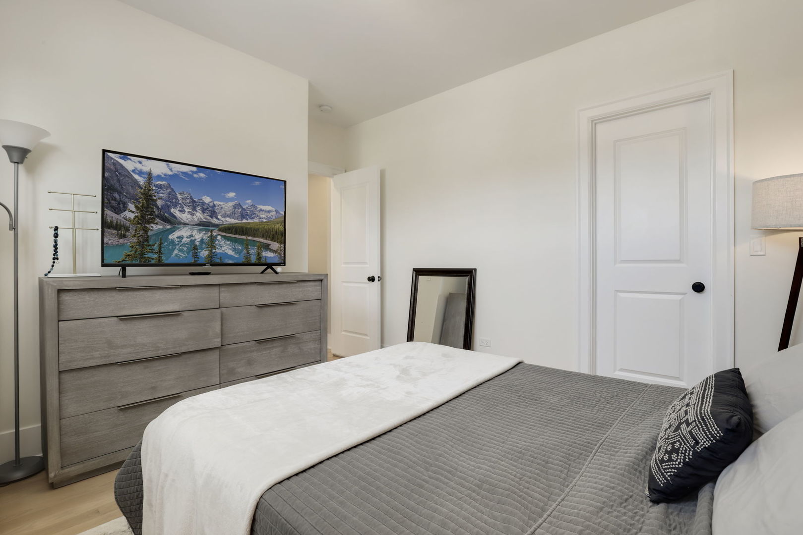 3048 West Lyndale Street, Unit 2 Chicago, IL 60647 - Photo 23 of 40 a bedroom with a bed and a flat screen tv