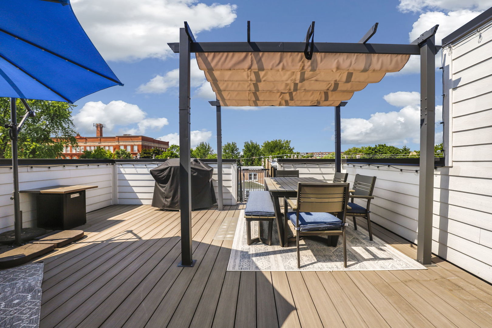 3048 West Lyndale Street, Unit 2 Chicago, IL 60647 - Photo 35 of 40 a view of a balcony with table and chairs under an umbrella