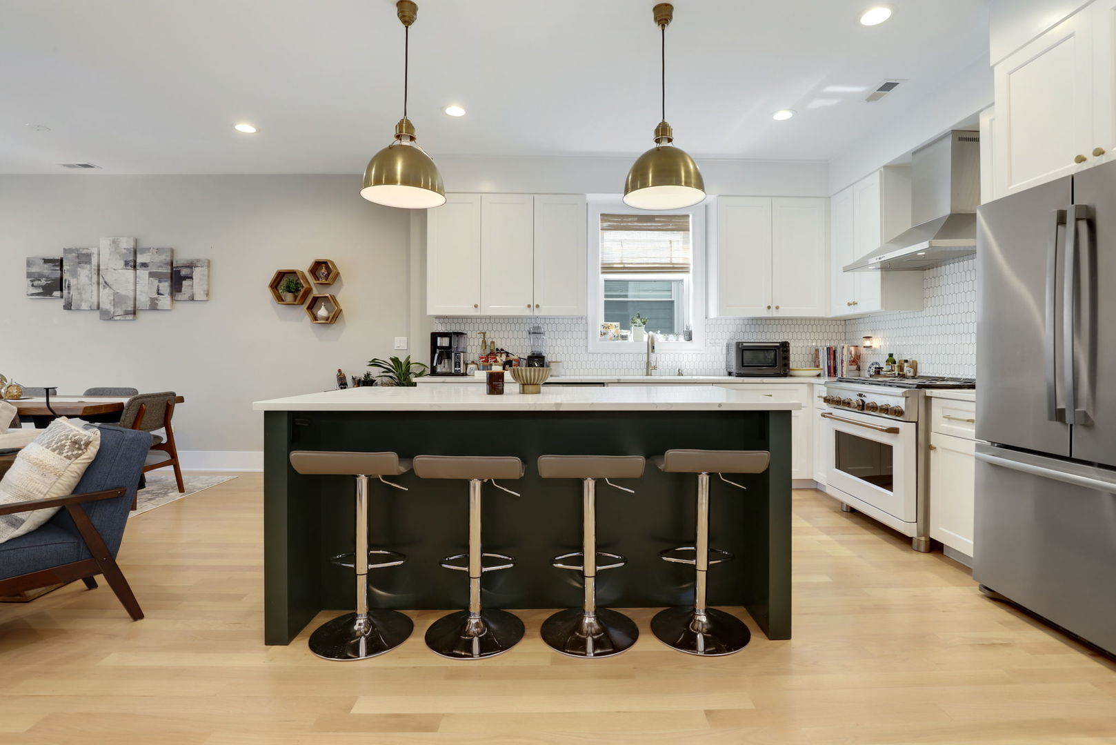 3048 West Lyndale Street, Unit 2 Chicago, IL 60647 - Photo 5 of 40 a kitchen with a table chairs sink and cabinets