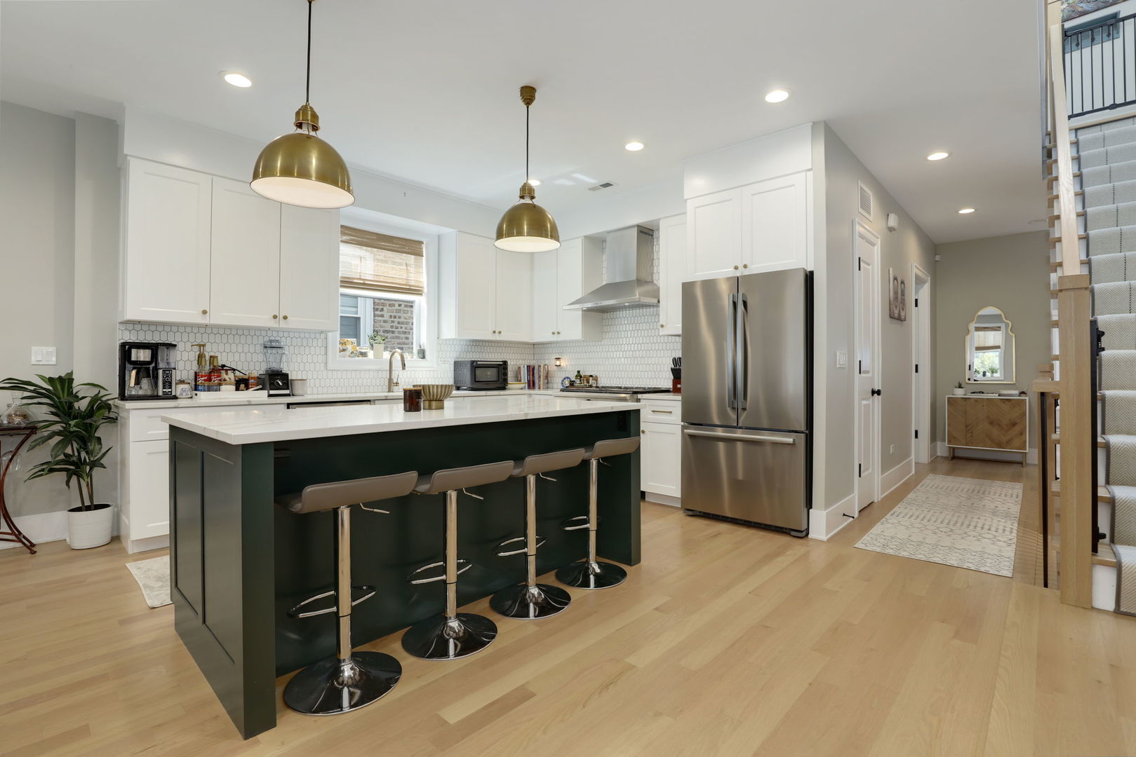 3048 West Lyndale Street, Unit 2 Chicago, IL 60647 - Photo 6 of 40 a kitchen with stainless steel appliances granite countertop a refrigerator a sink dishwasher and a stove with wooden floor