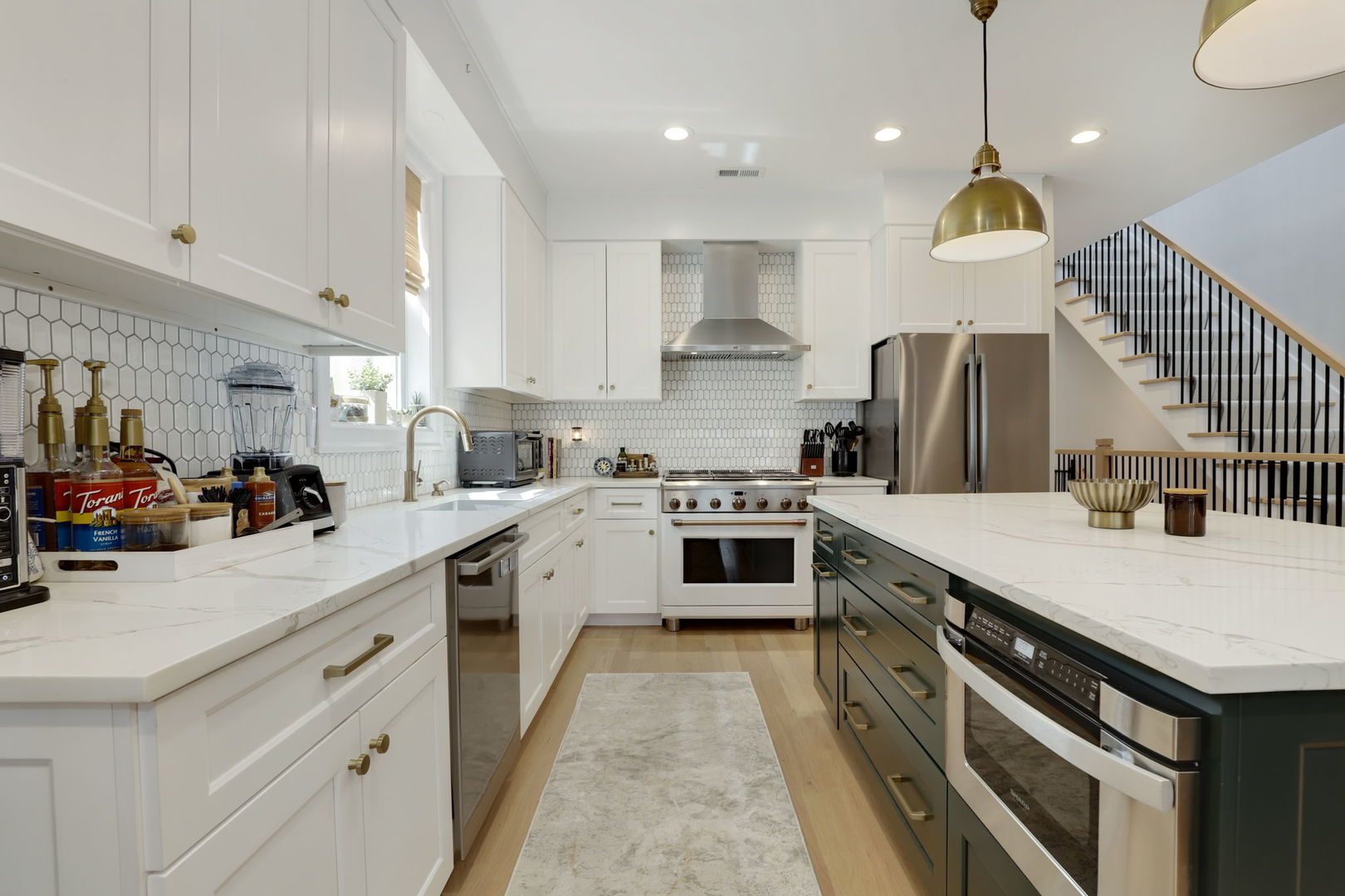 3048 West Lyndale Street, Unit 2 Chicago, IL 60647 - Photo 7 of 40 a kitchen with stainless steel appliances granite countertop a sink a stove and a refrigerator