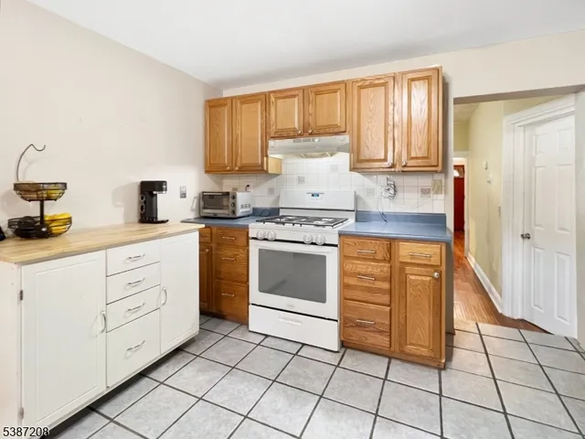 a kitchen with cabinets appliances and a window