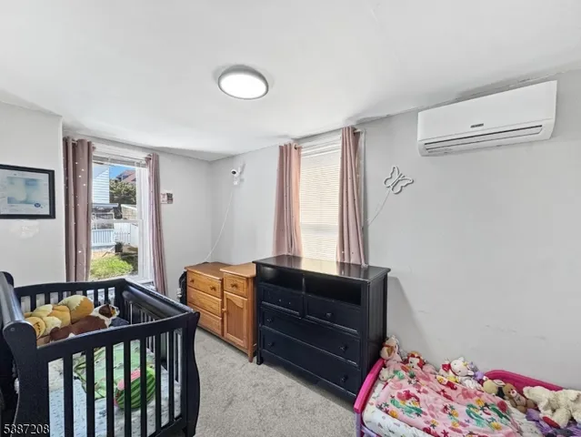 a bedroom with furniture and a window