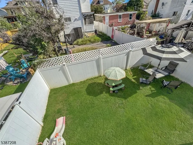 a backyard of a house with table and chairs