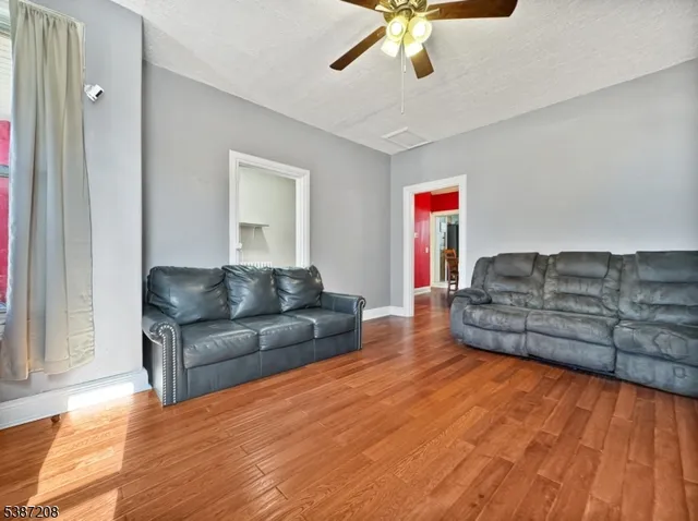 a living room with couches and a flat screen tv