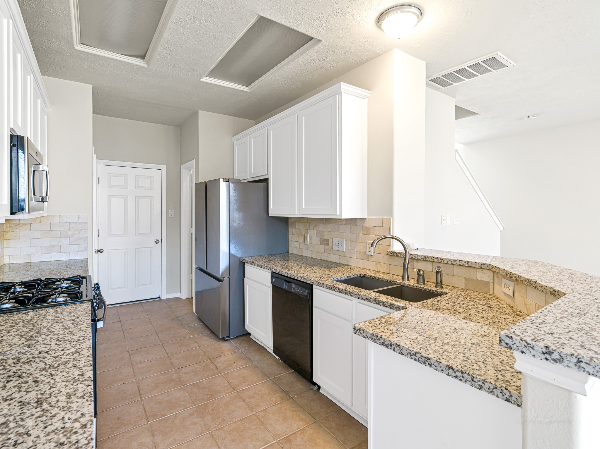 5631 Stonecloud Lane Katy, TX 77494 - Photo 13 of 31 a kitchen with a sink stove and refrigerator