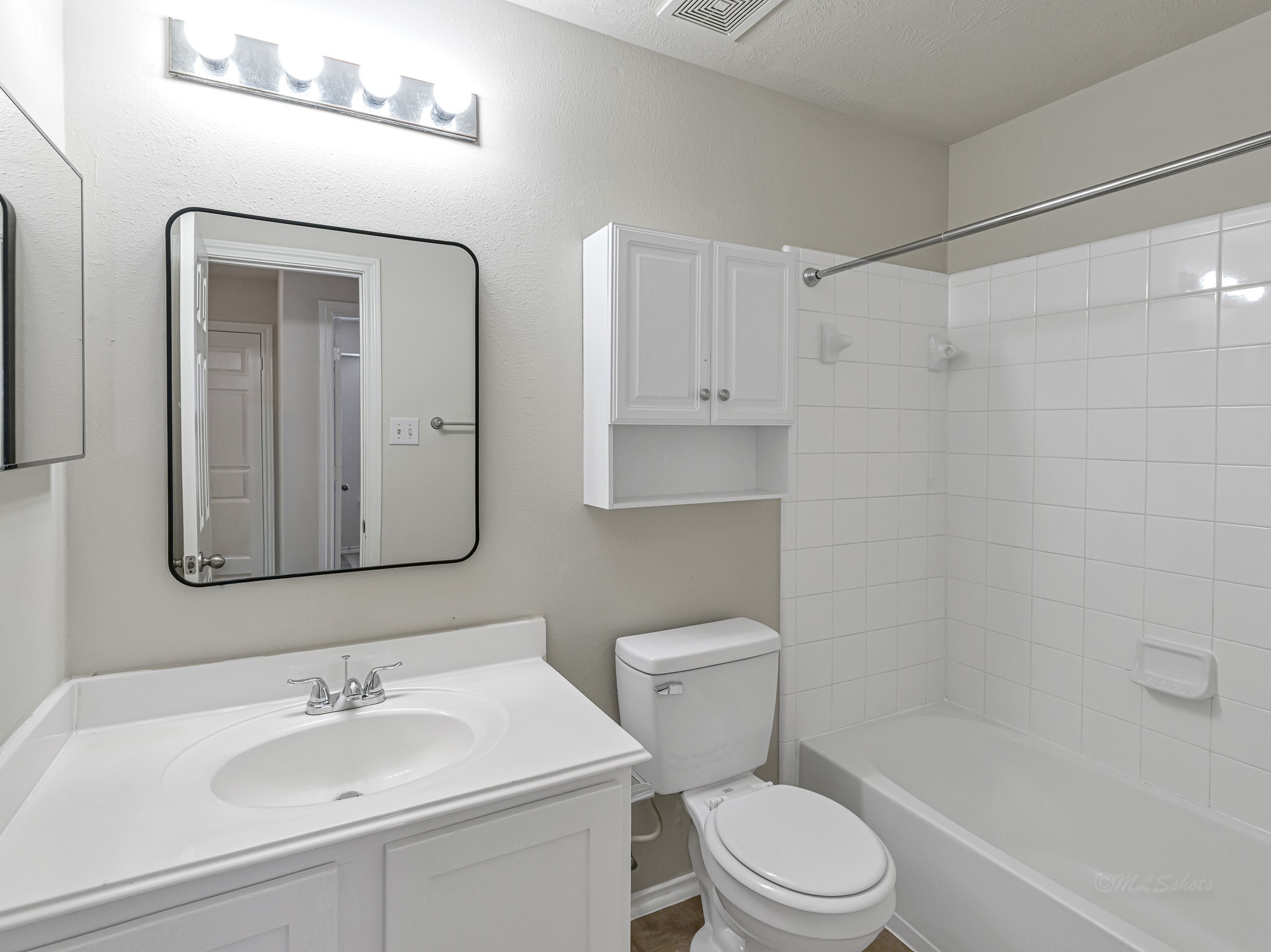 5631 Stonecloud Lane Katy, TX 77494 - Photo 19 of 31 a bathroom with a toilet a sink a mirror a bathtub and shower