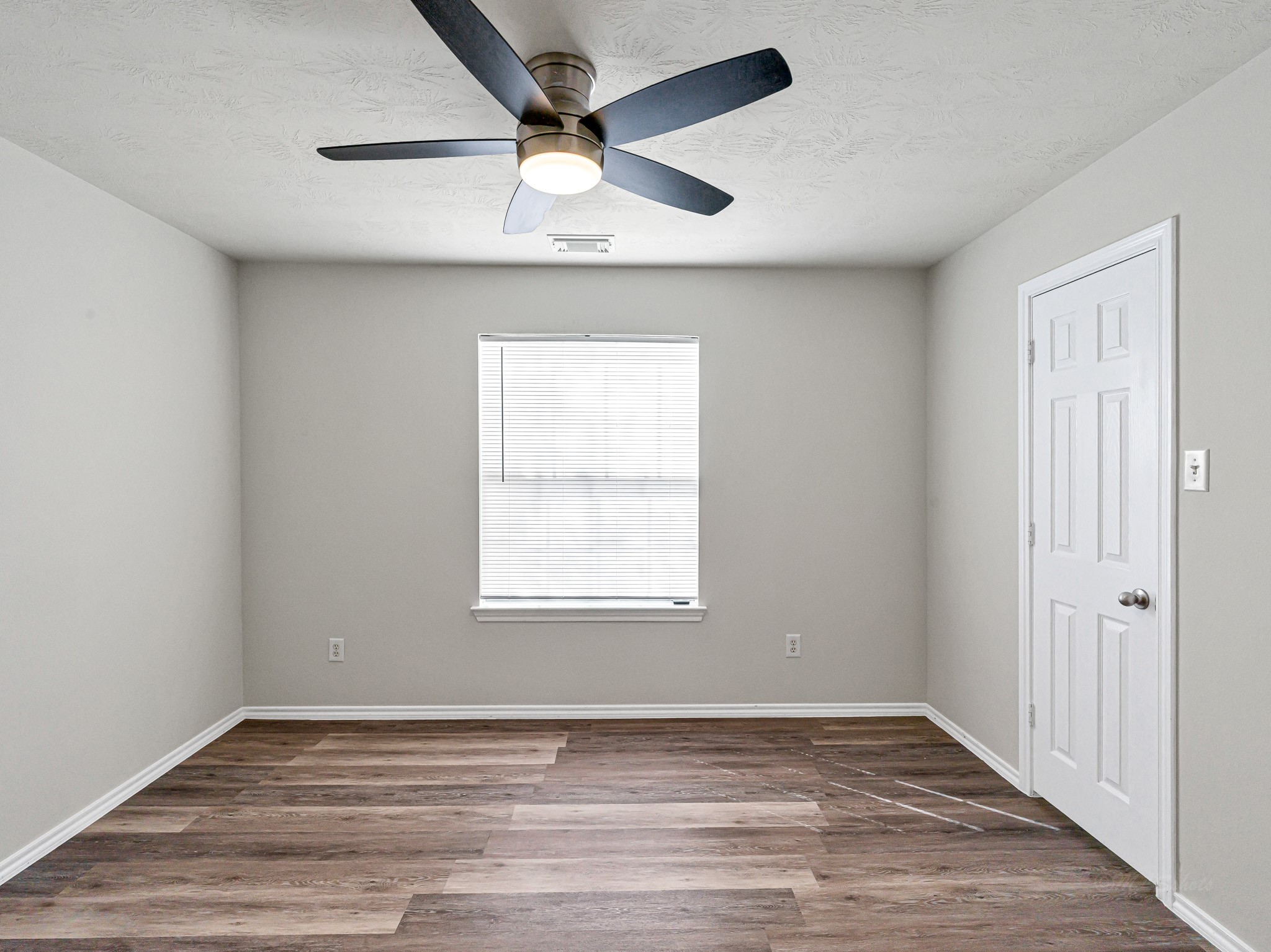5631 Stonecloud Lane Katy, TX 77494 - Photo 20 of 31 an empty room with wooden floor fan and windows
