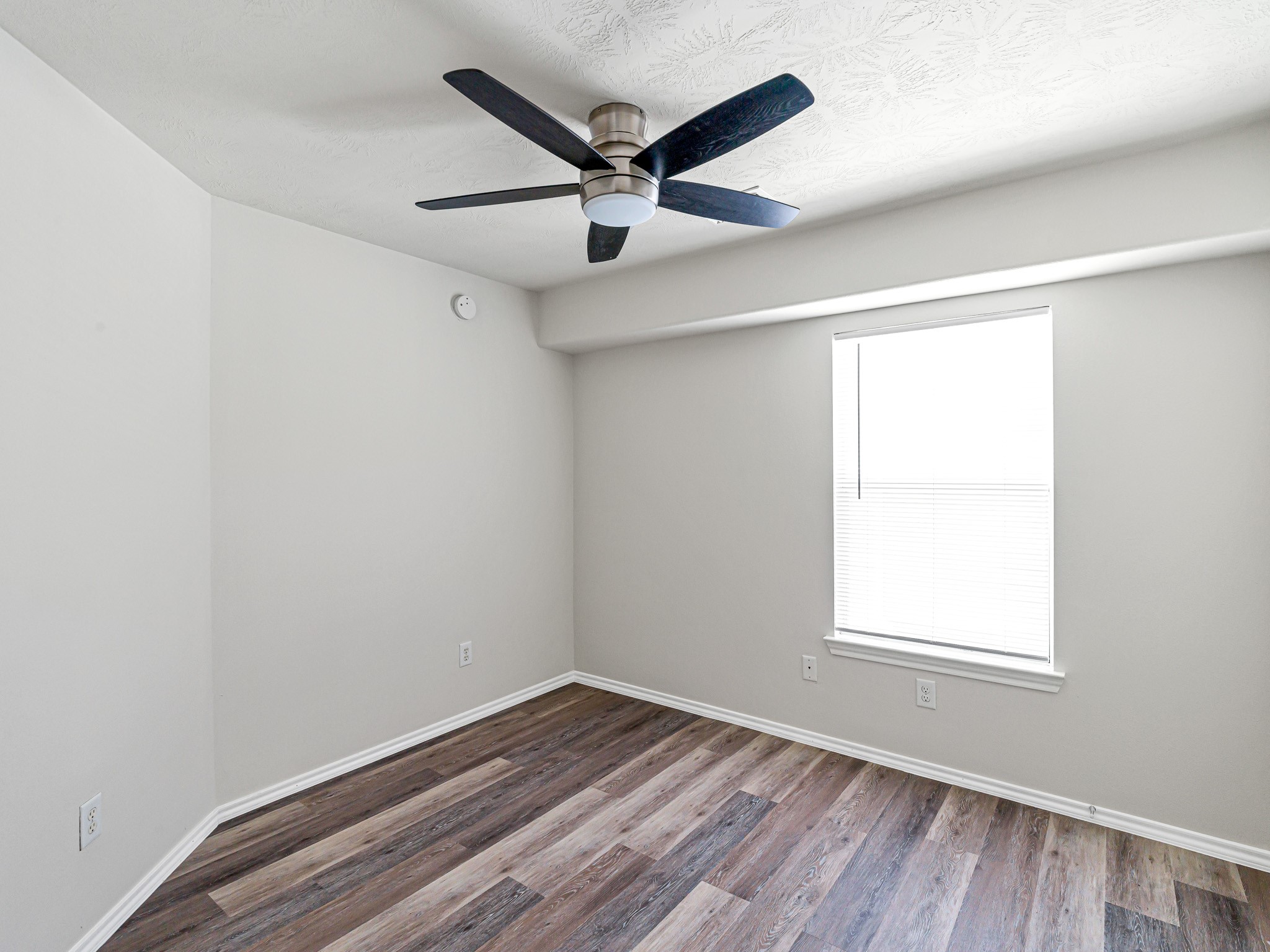 5631 Stonecloud Lane Katy, TX 77494 - Photo 21 of 31 an empty room with wooden floor ceiling fan and windows