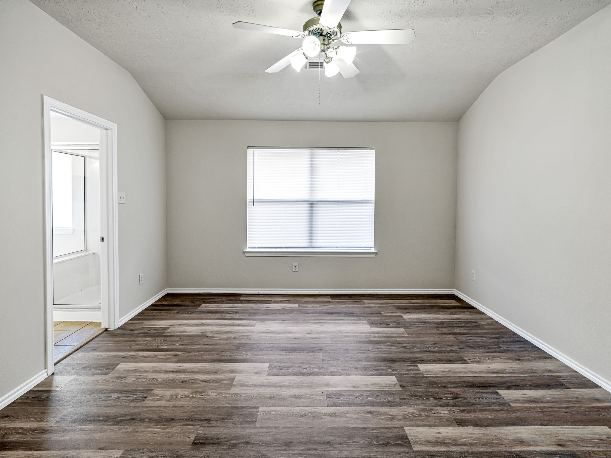 5631 Stonecloud Lane Katy, TX 77494 - Photo 23 of 31 an empty room with wooden floor chandelier fan and windows