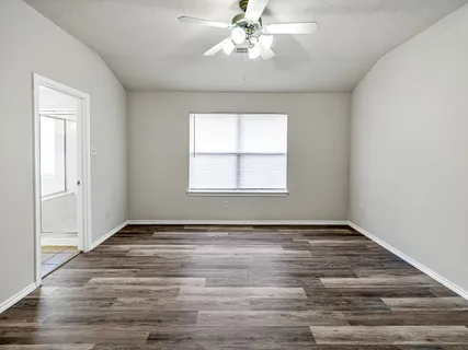 wooden floor in an empty room with a window