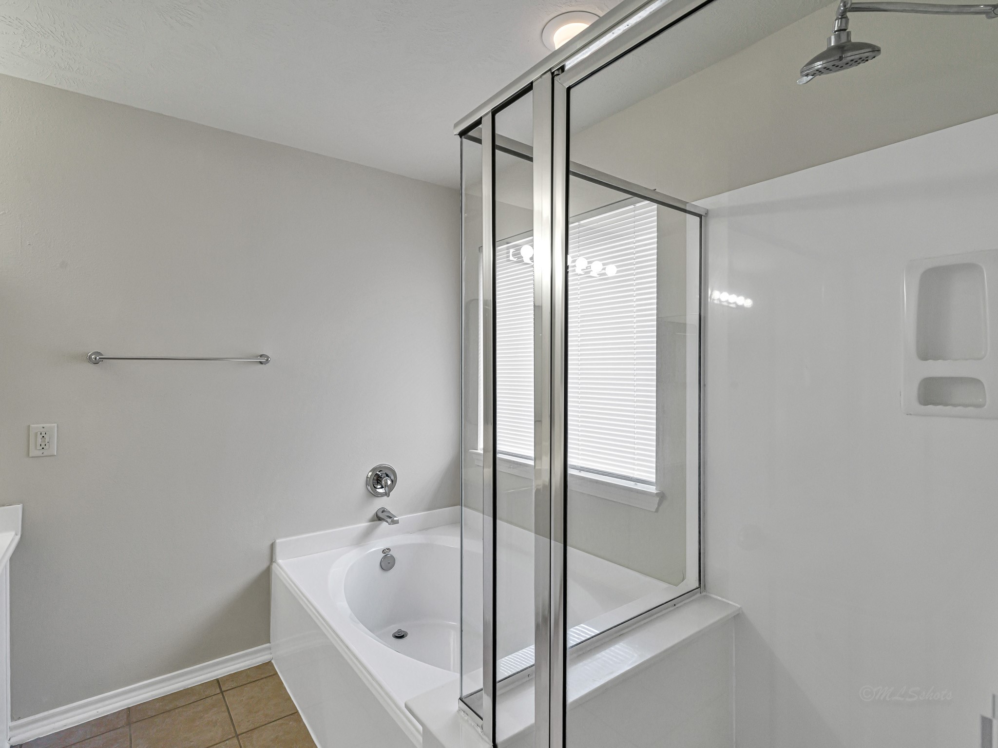 5631 Stonecloud Lane Katy, TX 77494 - Photo 25 of 31 a bathroom with a bathtub and a shower