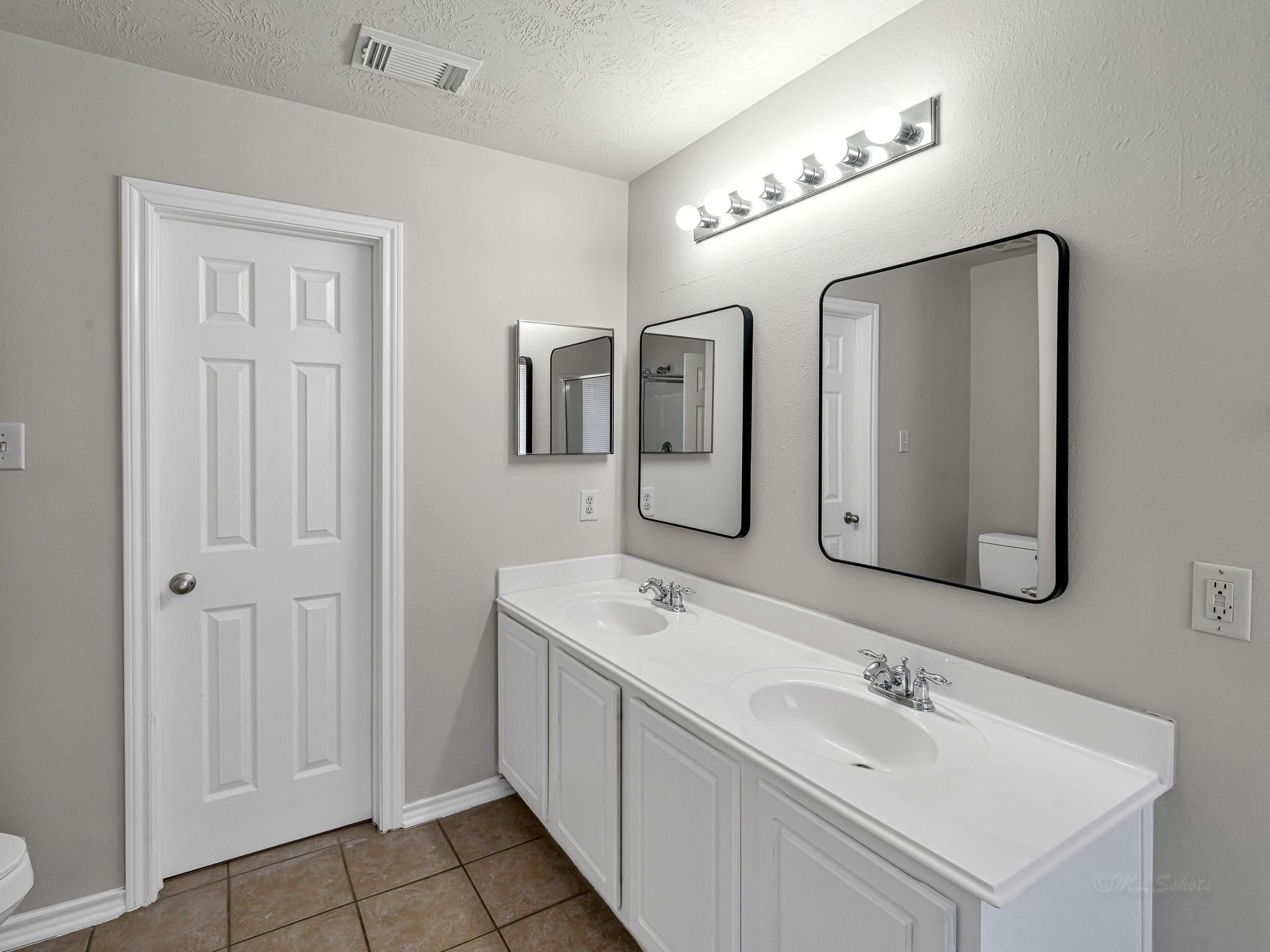 5631 Stonecloud Lane Katy, TX 77494 - Photo 26 of 31 a bathroom with double vanity sinks and a mirror