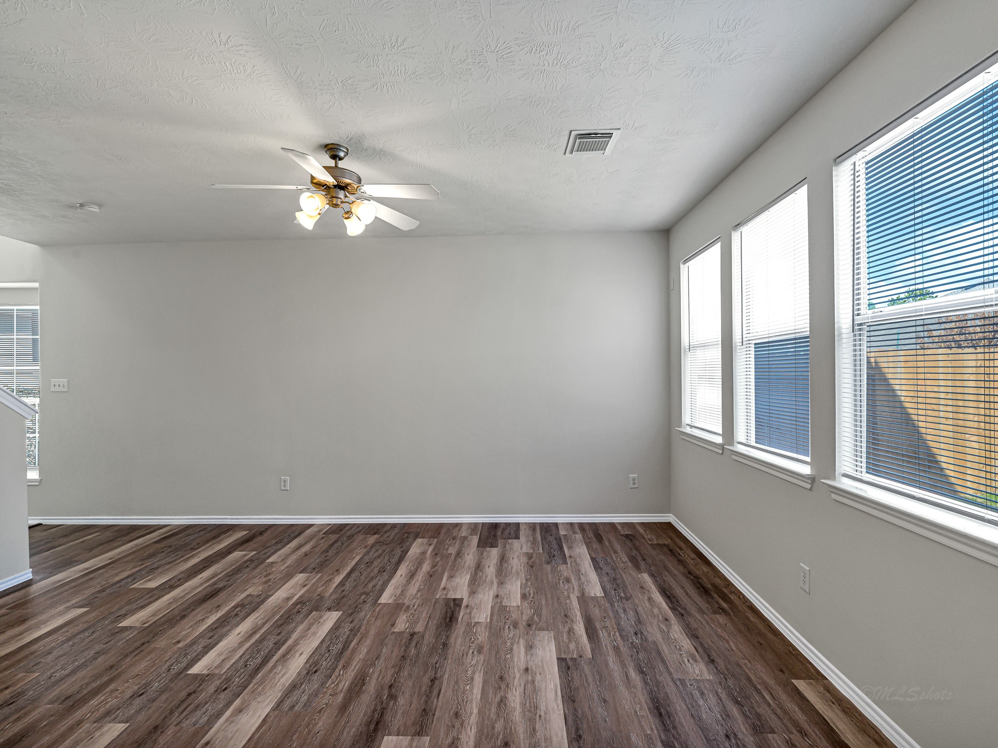 5631 Stonecloud Lane Katy, TX 77494 - Photo 9 of 31 wooden floor in an empty room with a window