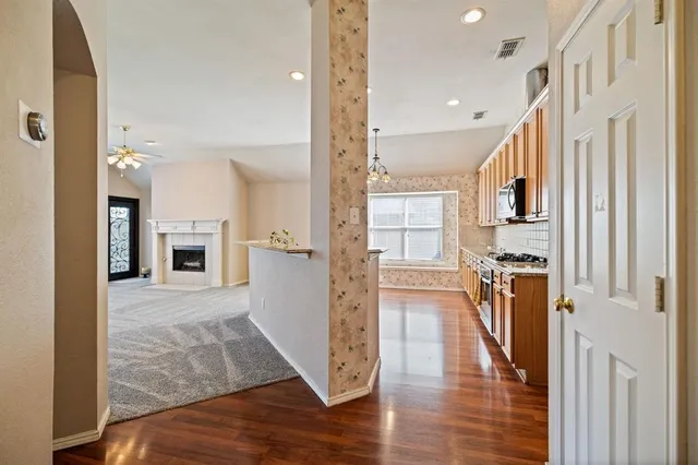 a view of a hallway view with wooden floor and staircase