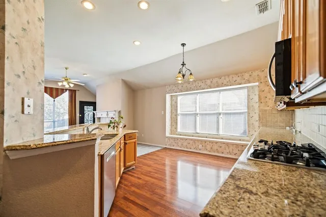 a view of a kitchen with a sink and wooden floor