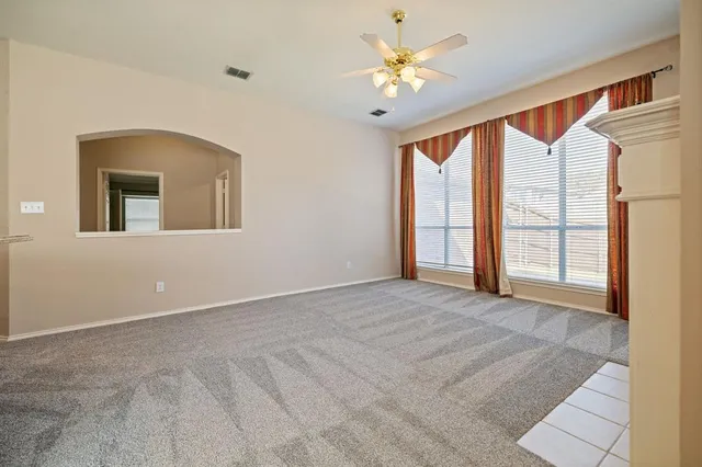 a large white kitchen with a large window