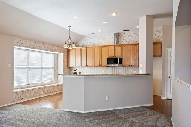 a view of a kitchen with a sink cabinets and a fireplace