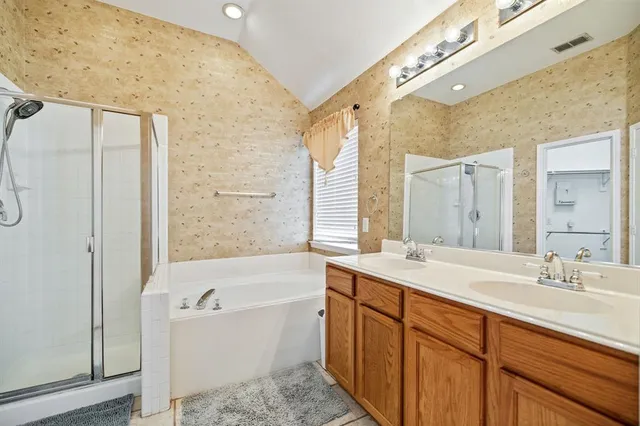 a bathroom with a tub sink and mirror