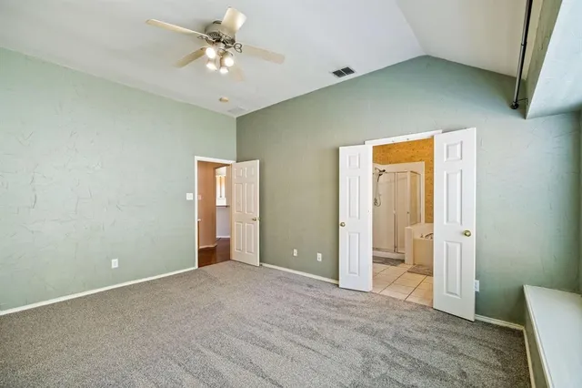 a view of a big room with closet and a ceiling fan
