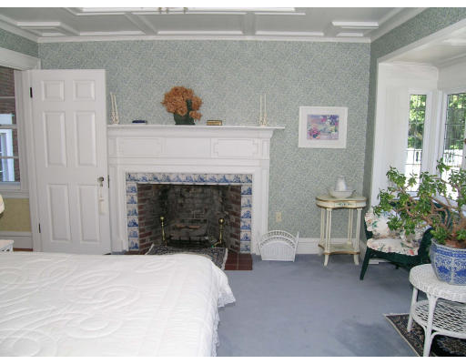 59 Wachusett Road Newton, MA 02467 - Photo 8 of 14 a bedroom with a bed and a fireplace