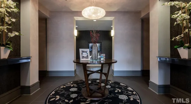 a kitchen with stainless steel appliances granite countertop a refrigerator and a view of living room