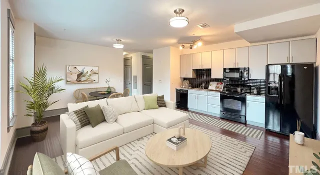 a living room with furniture and wooden floor