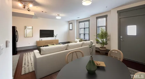 a kitchen with stainless steel appliances granite countertop a refrigerator a stove and a dining table with wooden floor