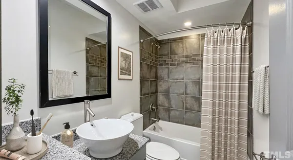 a kitchen with granite countertop a stove microwave and refrigerator