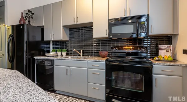 a bathroom with a granite countertop sink a mirror and shower