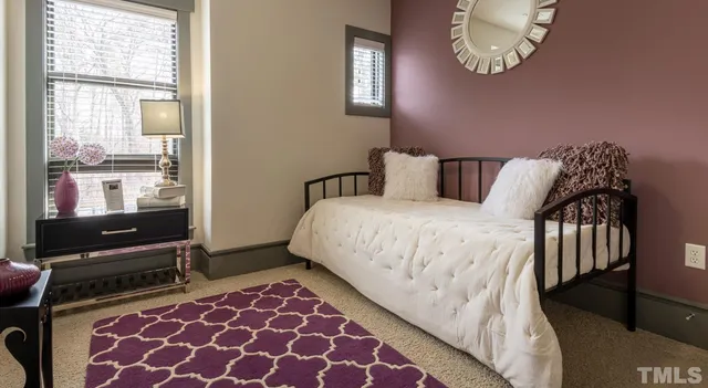 a living room with furniture and painting on the wall