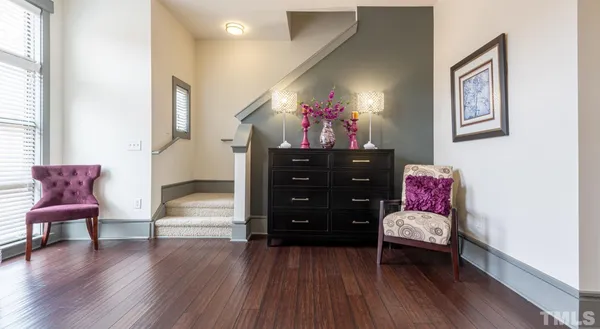 a table with chairs and wooden floor