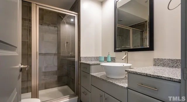 a bathroom with a granite countertop sink and a toilet