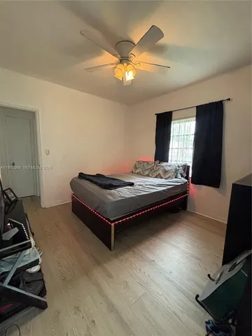 a bedroom with bed and window