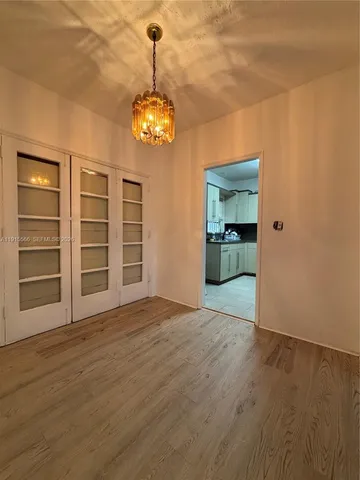 a view of a room with a stove and wooden floor