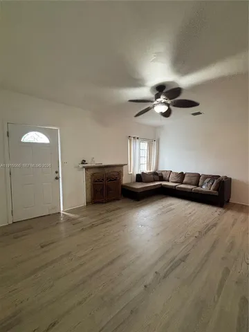 a view of a livingroom with a hardwood floor and a ceiling fan