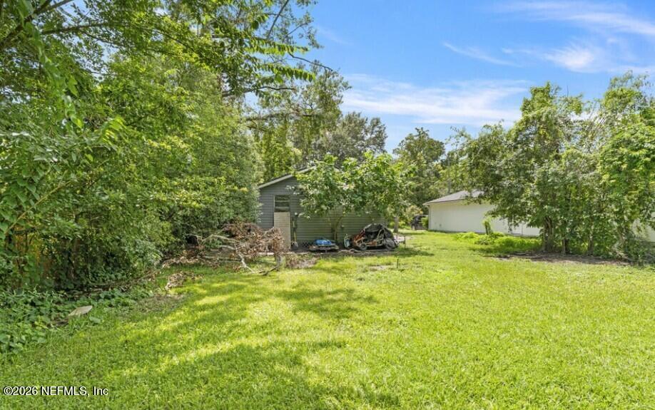 3131 Dignan Street Jacksonville, FL 32254 - Photo 15 of 16 a yellow house with trees in front of it